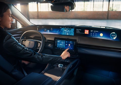 The driver of a 2024 Lincoln Nautilus® SUV interacts with the center touchscreen. | McKie Lincoln, Inc. in Rapid City SD